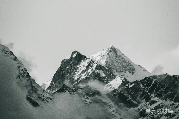 雪山披雪的黑白画面，云雾缭绕。