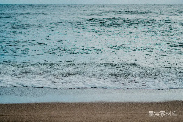 海滩上行走的人带着冲浪板