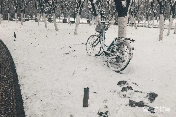 黑色通勤自行车停在覆有雪的地面上
