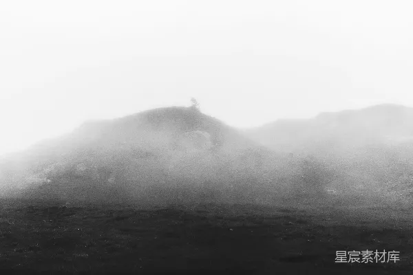一幅黑白照片中的朦胧山景