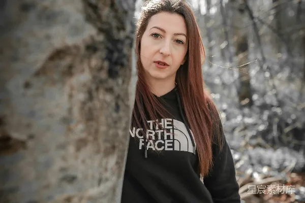 高清摄影 一位站在森林里树旁的女人