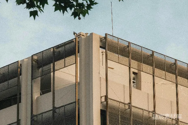 现代建筑，晴空万里，树梢可见。
