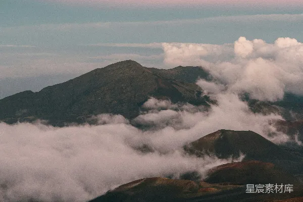 晨雾飘过崎岖山峰上的云层。