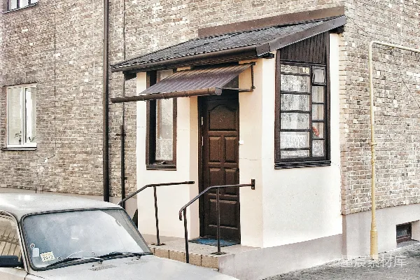 汽车停在砖砌建筑入口旁边