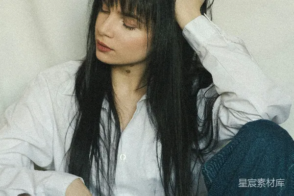 一头长发的妇女坐在椅子上。
