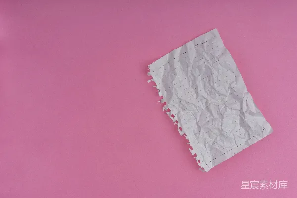 高清摄影 一张白色的纸放在粉红色的表面上。