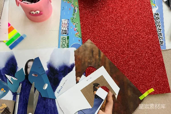 高清摄影 凌乱的办公桌上摆放着剪刀、制作材料和用于拼贴画的纸张。