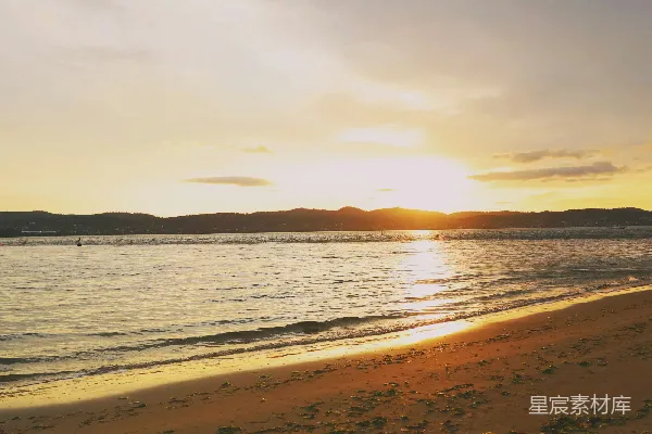 海滩上的太阳正缓缓沉入水中