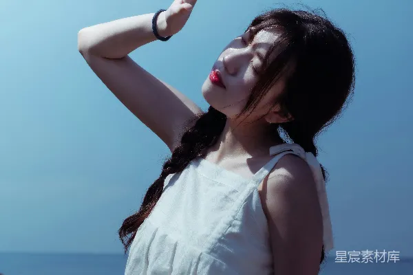 一个女人站在一片水域旁边