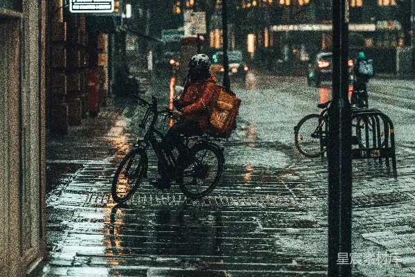 黑色夹克的人在白天骑自行车经过人行道