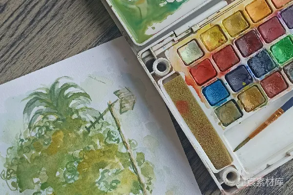 高清摄影 一盒水彩颜料和一幅树的画作
