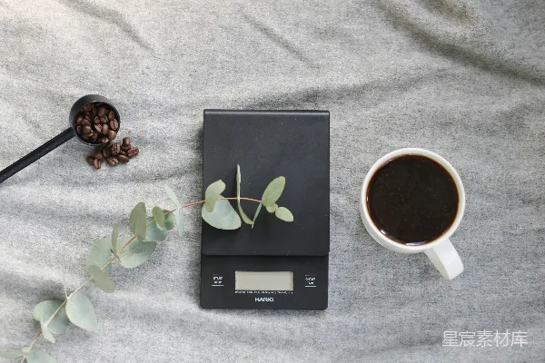 一个茶匙，一杯咖啡和一把勺子放在一张床上
