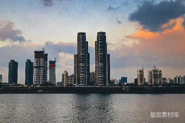 城市天际线在夕阳映照下的水面之上