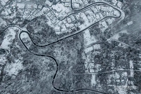 高清摄影 一条蜿蜒的道路穿过被雪覆盖的村庄。