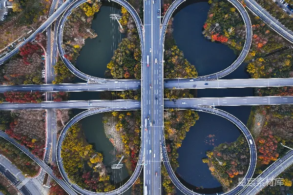 高清摄影 一座复杂的高速公路交汇处的航拍图，可以看到车辆在行驶。
