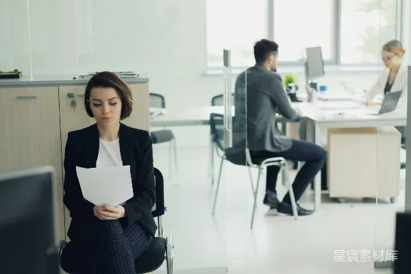 高清摄影 坐在办公室里的女人手里拿着文件。