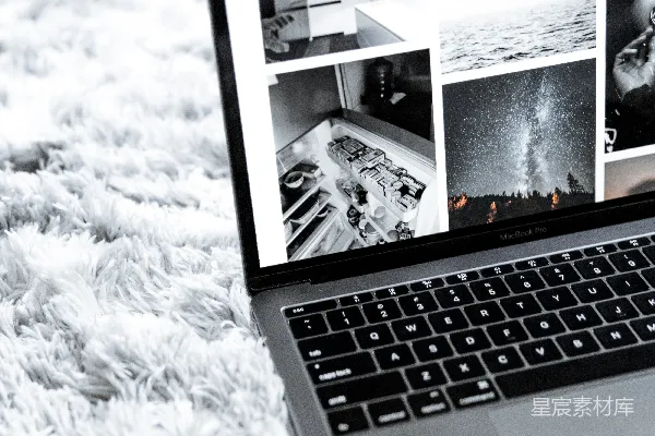 高清摄影 打开的 MacBook Pro 放在灰色地毯上