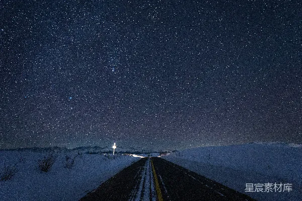 高清摄影 一条覆盖着雪的路，天空中满是星星。