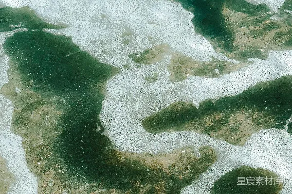 高清摄影 一幅被雪覆盖的水域和陆地的空中俯瞰图