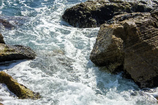 高清摄影 泡沫般的海水拍打着崎岖的黑岩石。