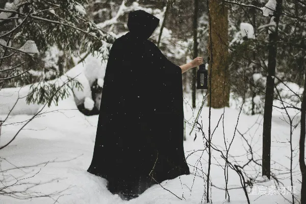 高清摄影 一个穿着黑斗篷的人站在雪地里