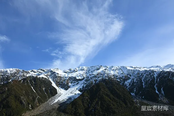 高清摄影 一座覆盖着积雪的山脉在蓝天之下