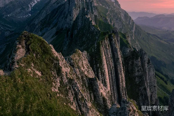 高清摄影 日落时分，壮观的山峰和绿色的山坡。