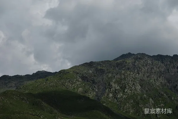 高清摄影 一座山峰，背景是阴云密布的天空。
