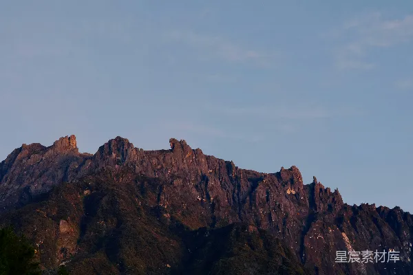 高清摄影 崎岖的山峰沐浴在温暖的夕阳光辉下。