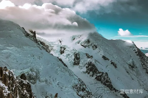 高清摄影 白天多云天空下的积雪覆盖的山峰