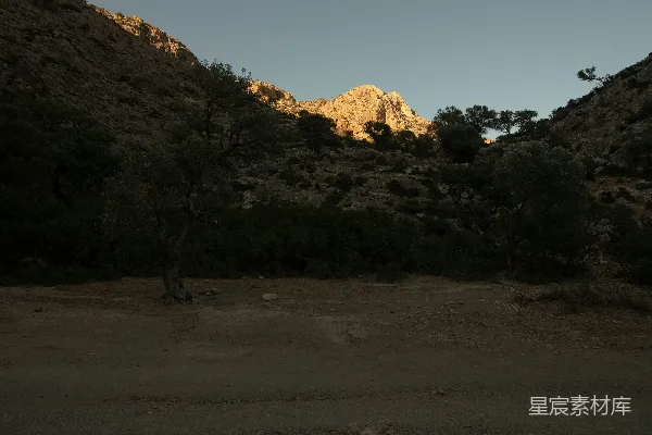 高清摄影 夕阳正在落向一座岩石山。