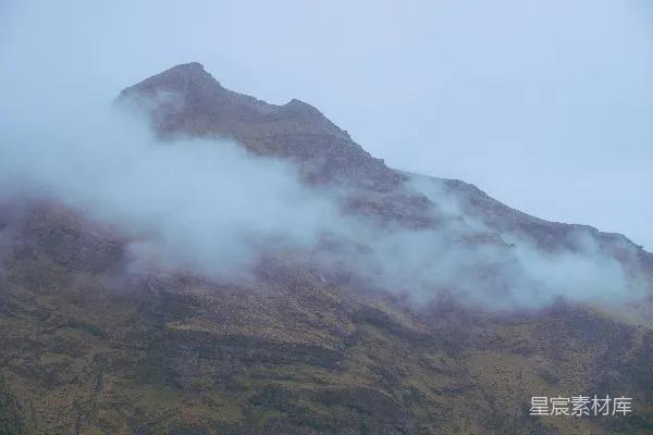 高清摄影 一座被雾气和云层笼罩的高大山脉。