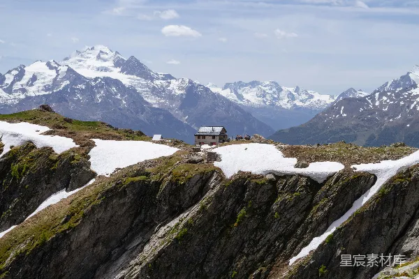 高清摄影 蓝天下的雪山之巅上的山间小屋。