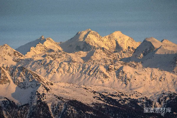 高清摄影 白雪覆盖的山峦沐浴在金色阳光中