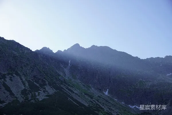 高清摄影 戏剧性的阳光穿透黑暗的山脊。