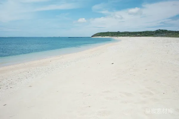 高清摄影 一个沙滩，蓝色的海水和远处的山丘