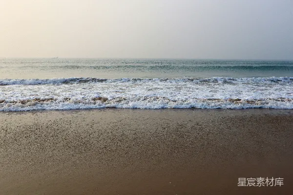 高清摄影 一个海滩，海浪涌向岸边。