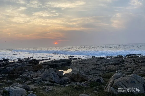 高清摄影 太阳正落向海洋和岩石。