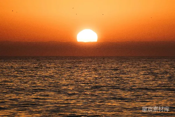 高清摄影 夕阳西下，海面上有一艘小船。