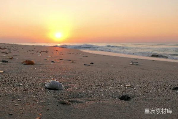 高清摄影 夕阳正洒在海面，海滩上夕阳西下。