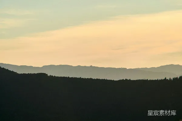 高清摄影 夕阳西下，水面上方，远处有一座山。