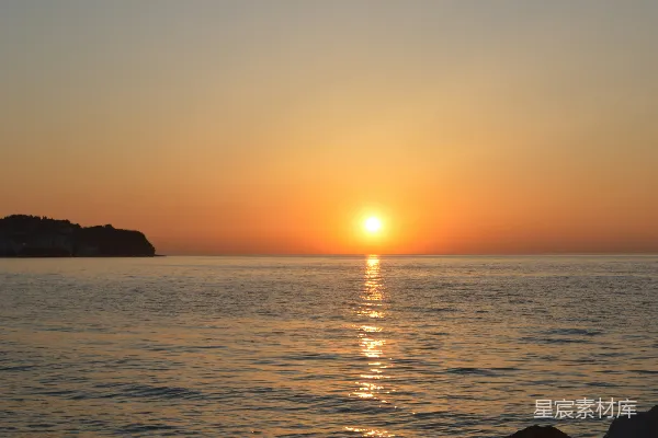 高清摄影 岩石海滩上，夕阳正在落下。