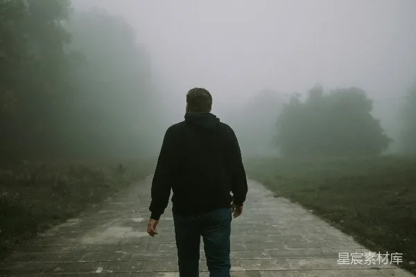 高清摄影 一个男人在雾中沿着小路行走。