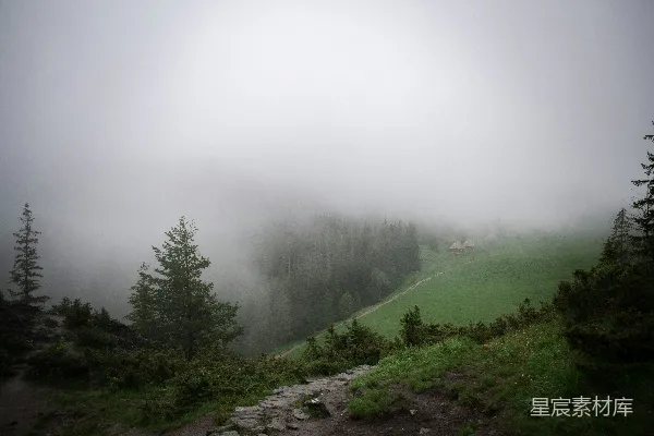 高清摄影 雾蒙蒙的山峰，前景中有小径。