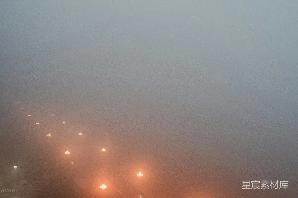 高清摄影 橙色的灯光照亮了夜晚雾蒙蒙的公路。