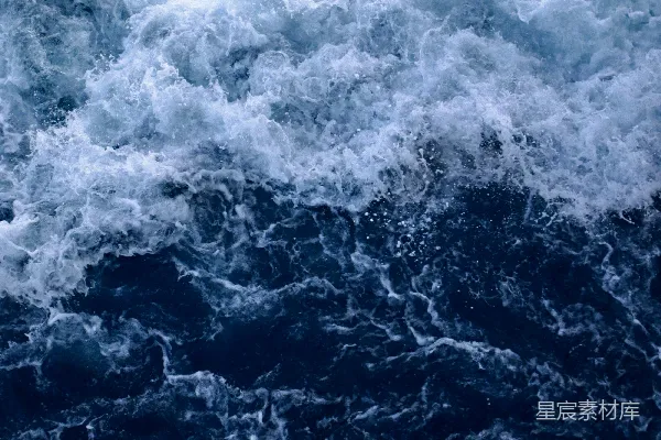 高清摄影 一个骑在冲浪板上的人在海浪上漂浮。