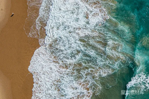 高清摄影 航拍视角下的海浪拍打着沙滩的场景。