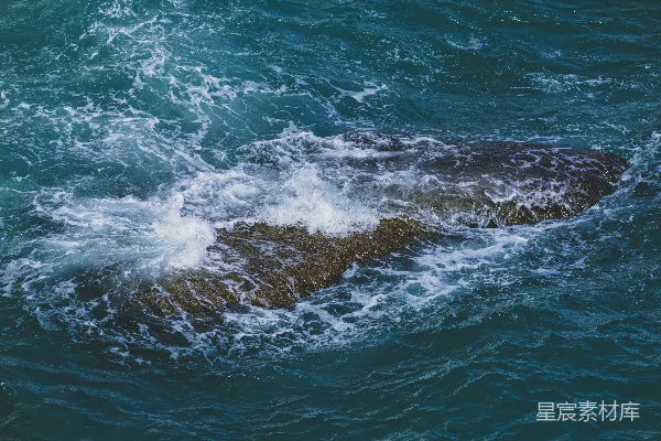 高清摄影 海浪拍打着海中的一块沉没的岩石。
