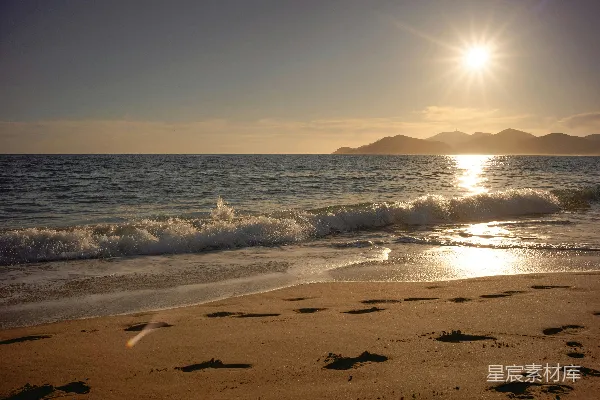高清摄影 夕阳西下，海浪轻轻拍打着沙滩。