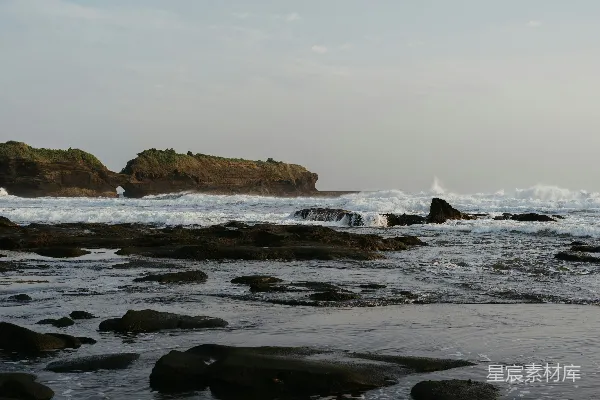 高清摄影 黄昏时分，海浪拍打着岩石海岸。